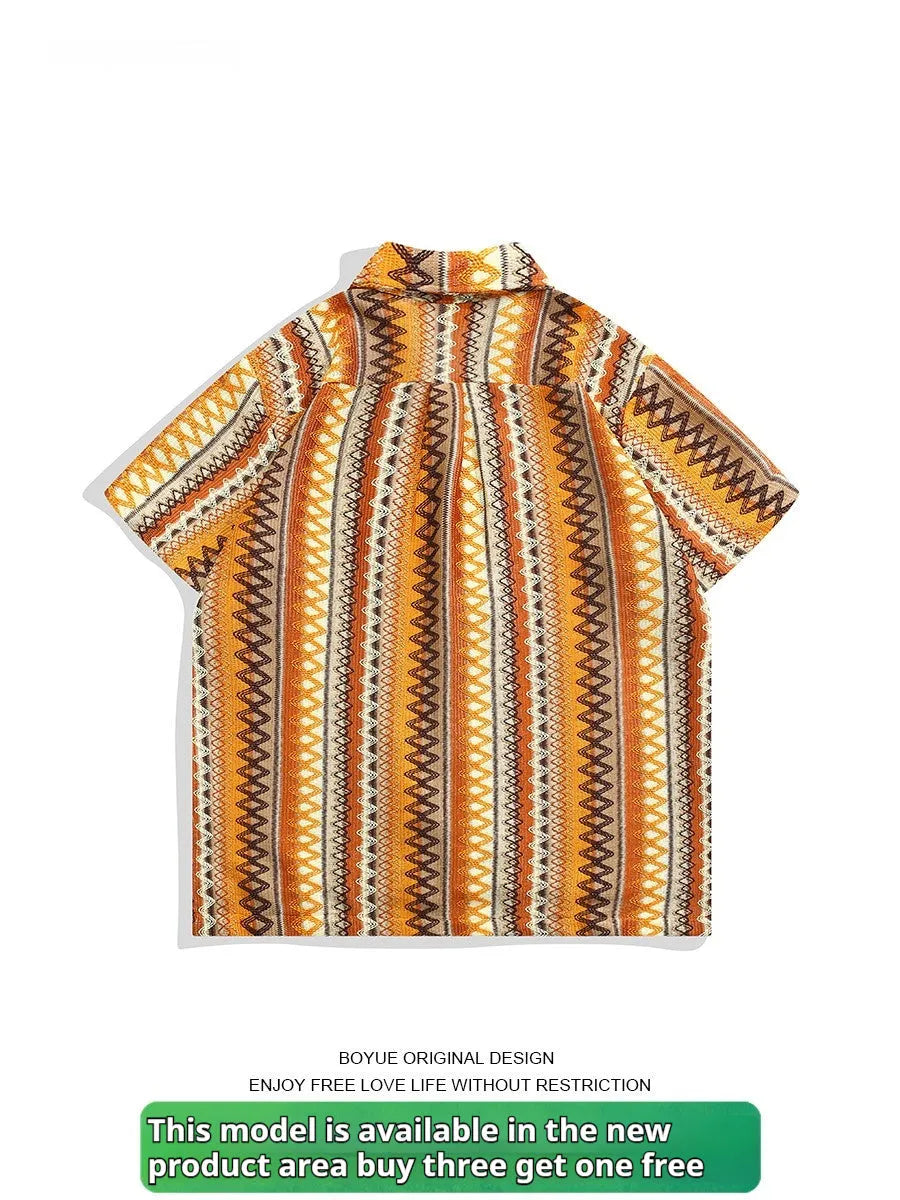 Loose fit ethnic style woven Cuban collar shirt in contrasting colours on a hanger.
