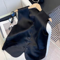 Black satin vest with sleeveless design and splicing details, shown on hanger