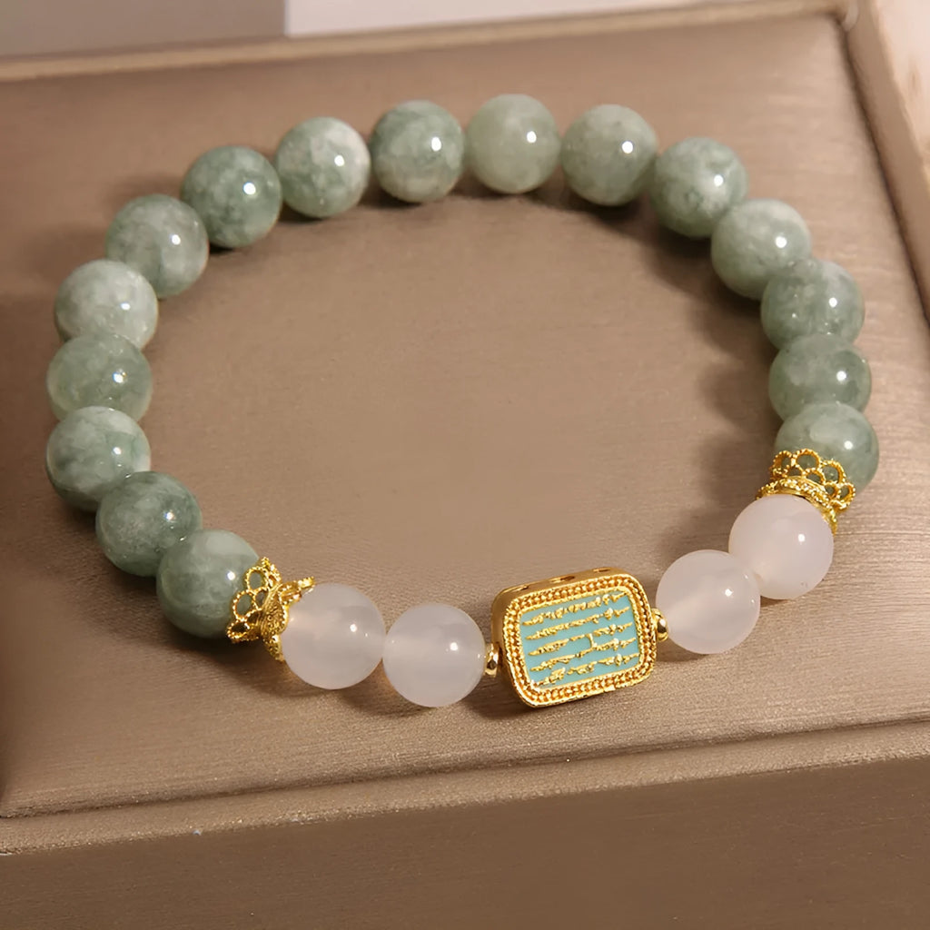 Natural oil green emerald crystal bracelet with five beads on a black elastic cord.