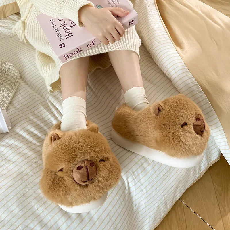 Light brown women's fleece slippers with a cartoon pattern, artificial wool lining, and a PVC sole.
