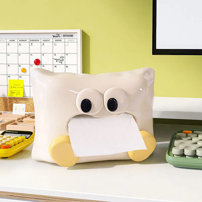 White ceramic tissue box holder with lid on a wooden coffee table.