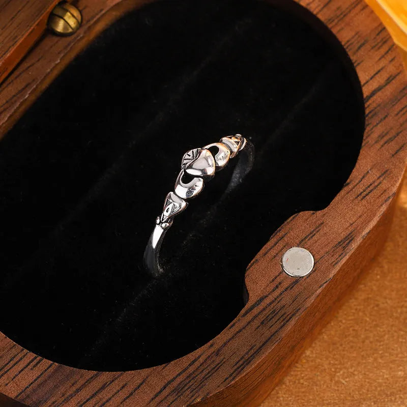 Retro silver coloured open band heart ring made of copper for women.