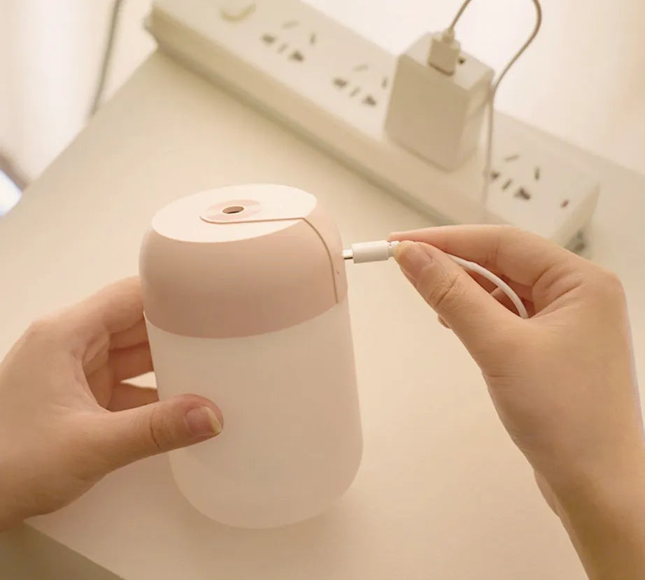 White cylindrical USB mini humidifier with charging cable, measuring 15cm height