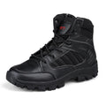 Men's black high-top hiking shoe with metal accents and PU upper on a rocky outdoor path.
