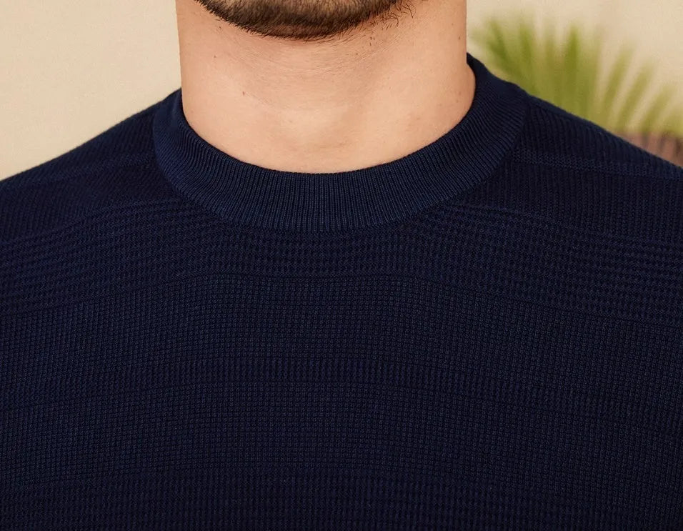Pure cotton short sleeve T-shirt in off-white with a round neck, laid flat