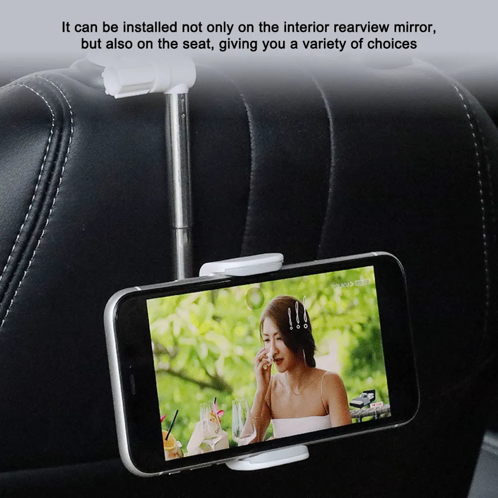 Black car phone holder mounted on rearview mirror with mobile phone secured in adjustable bracket
