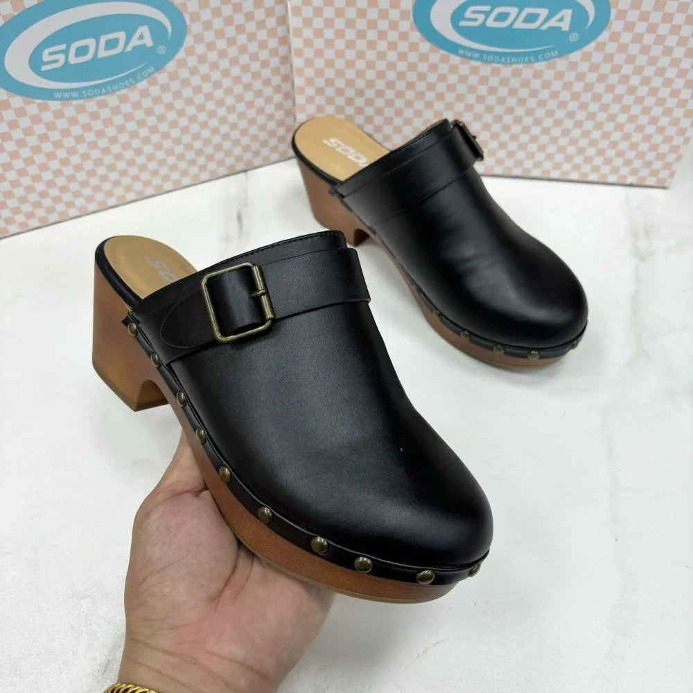 Black retro chunky heel slippers with closed toe and silver rivet details on a rounded toe.