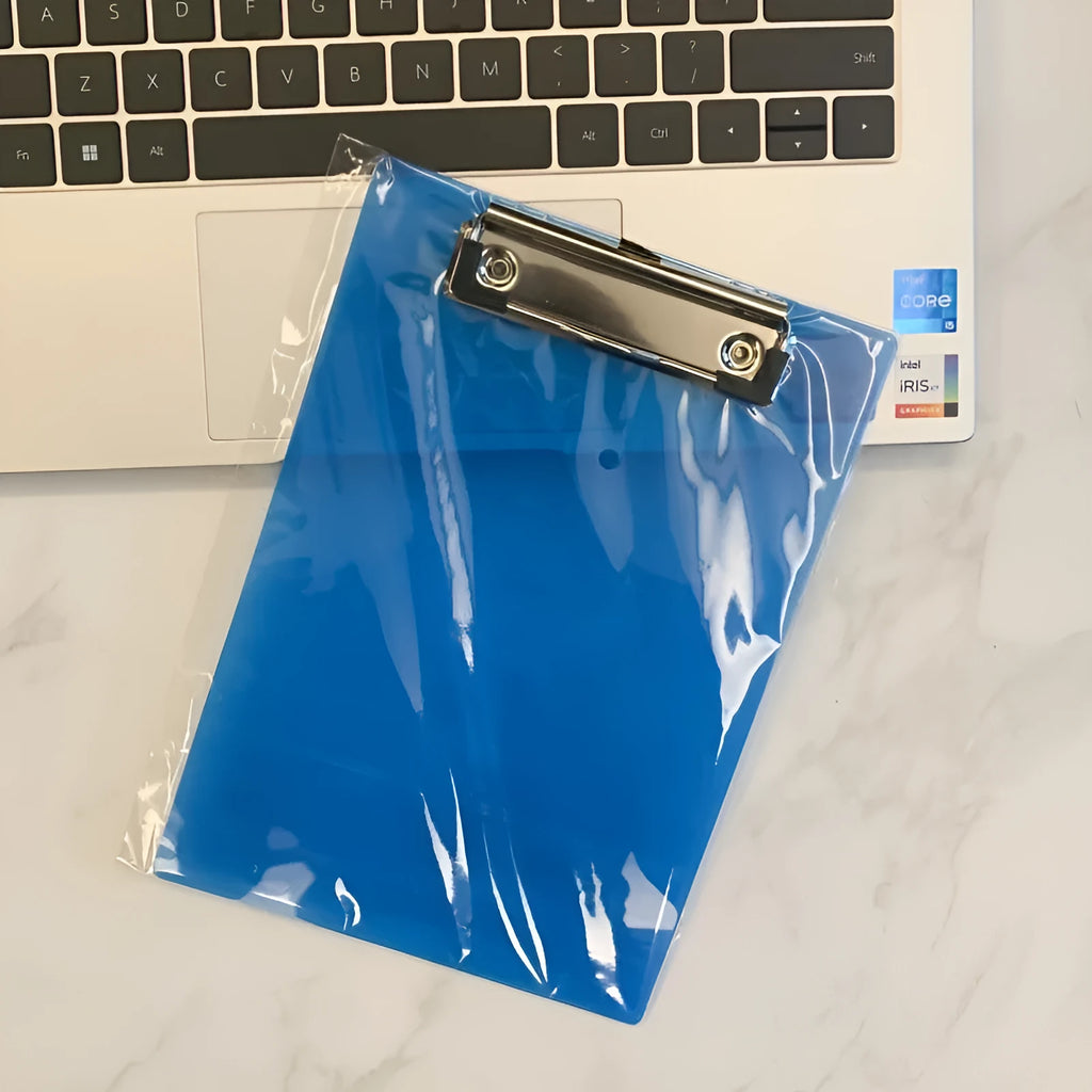 Clear A4 plate holder with metal clip and transparent writing pad in blue colour on a desk.