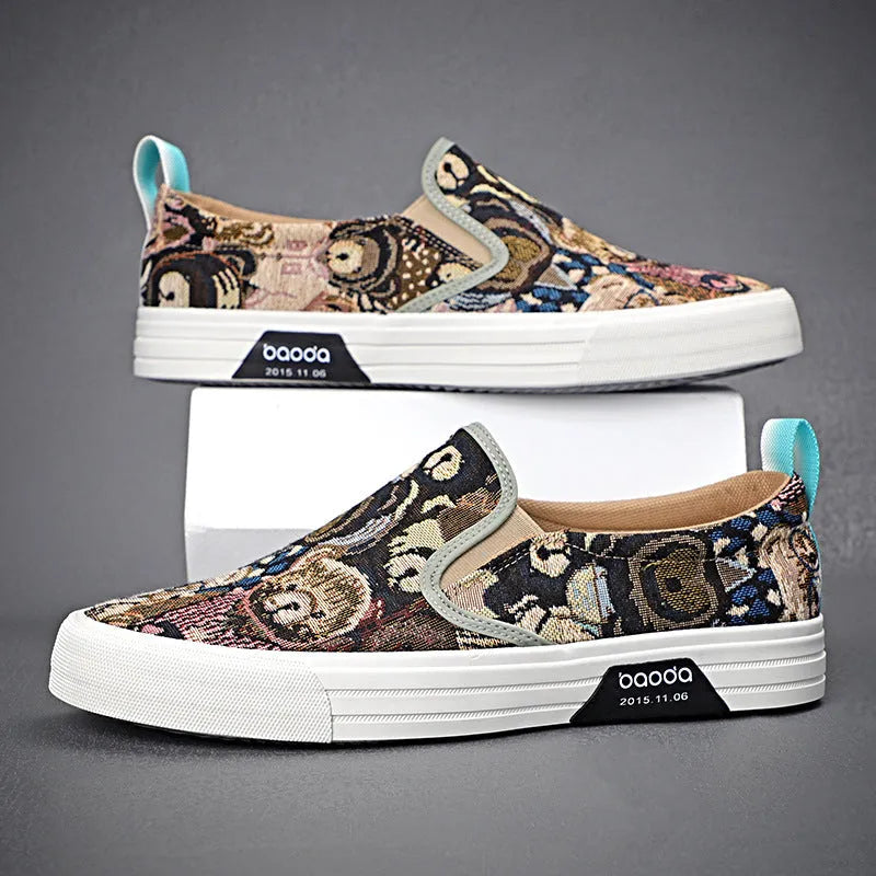 A pair of khaki-coloured canvas slip-on sneakers with a low-top profile, round toe, and vulcanised rubber sole on a plain background.