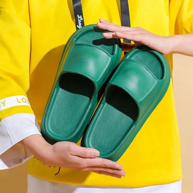 EVA flip-flop slippers with thick sole in multiple colours on a bathroom floor