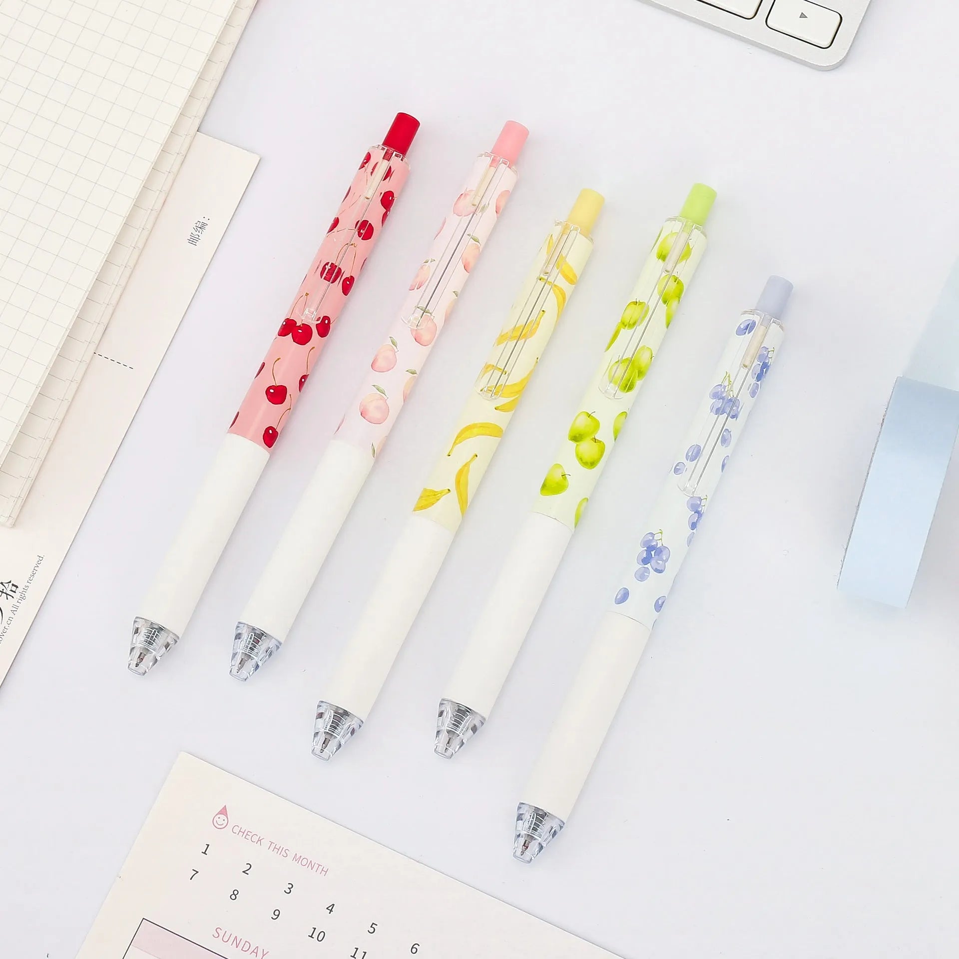 Three fruit-scented press pens with 0.5mm black ink refills and plastic barrels