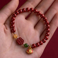 Handcrafted cinnabar bracelet with emperor sandstone beads and traditional fu character design in New Chinese style