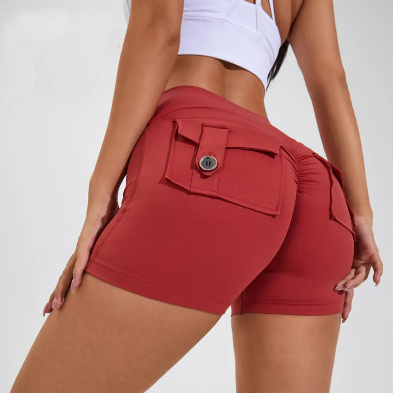 Women's high waist hip lifting shorts in avocado green with side pockets during yoga pose