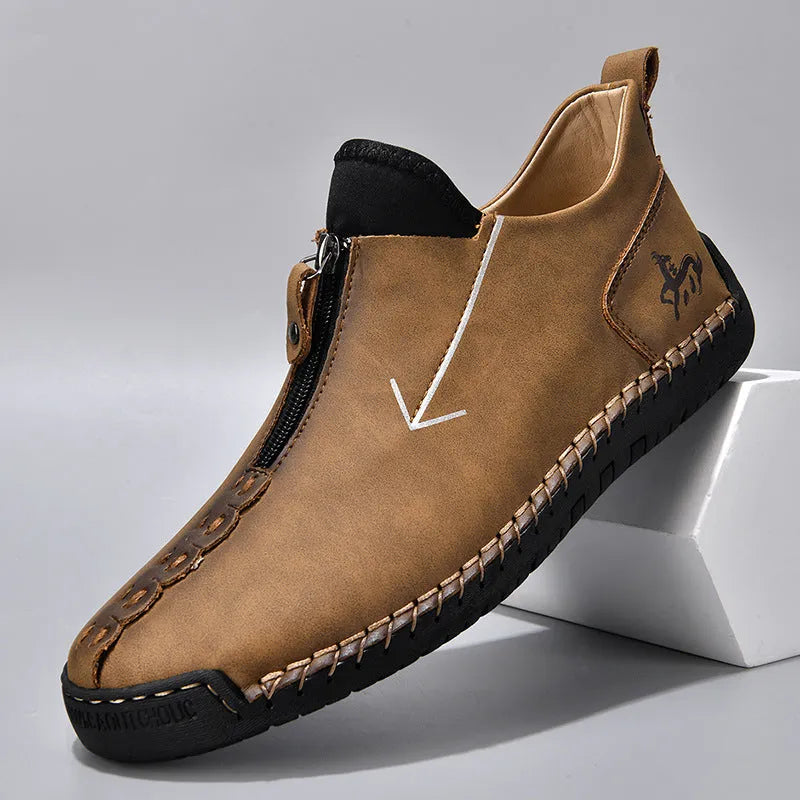 Men's black leather boots with front zipper, hand-stitched sole, and mid-calf length