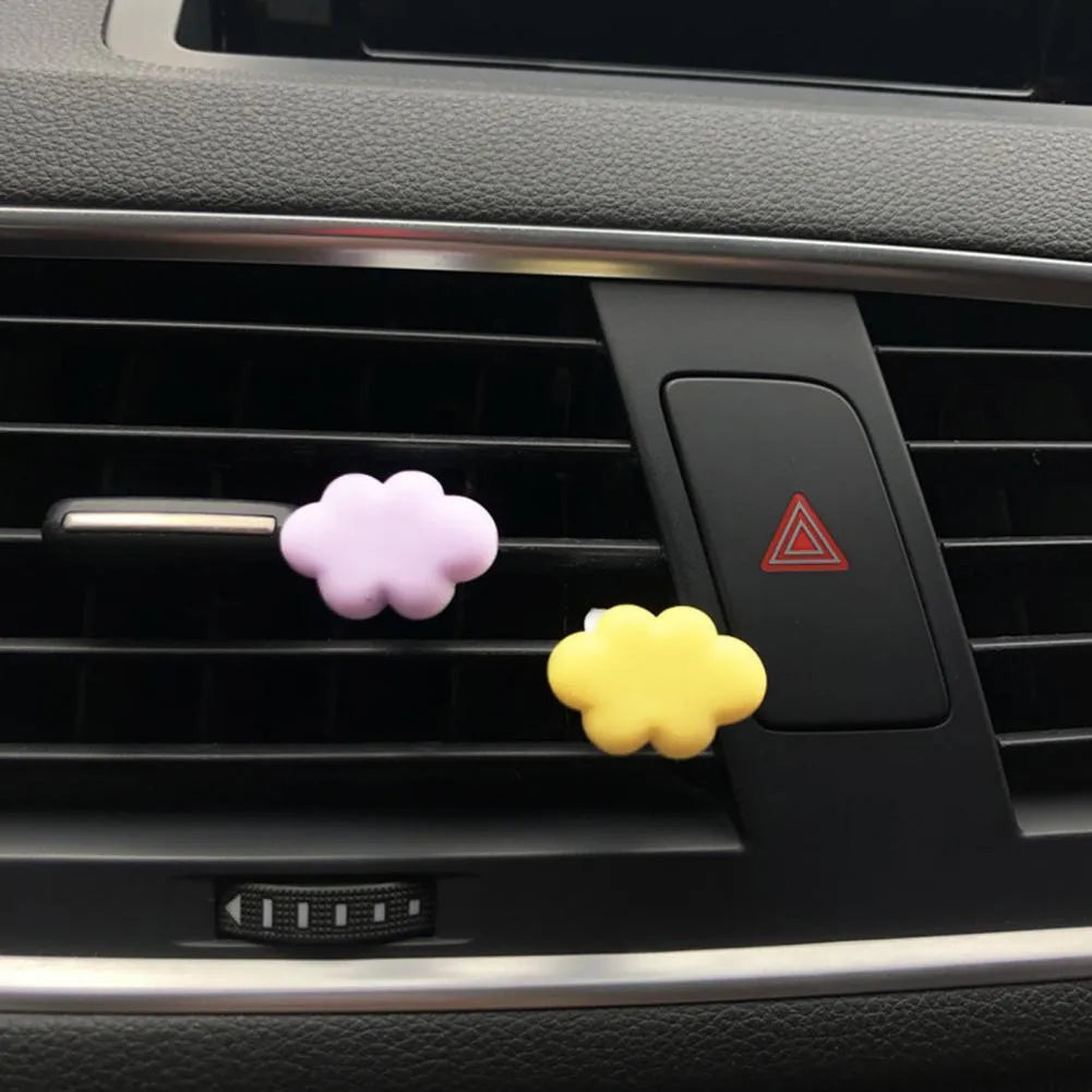 Resin cartoon car fragrance clip in light green colour, dimensions 17mm by 27mm, on a car air vent