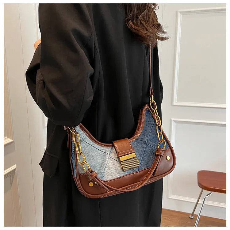Brown denim women's bucket shoulder bag with diamond mesh detail, chain accents, and double adjustable straps