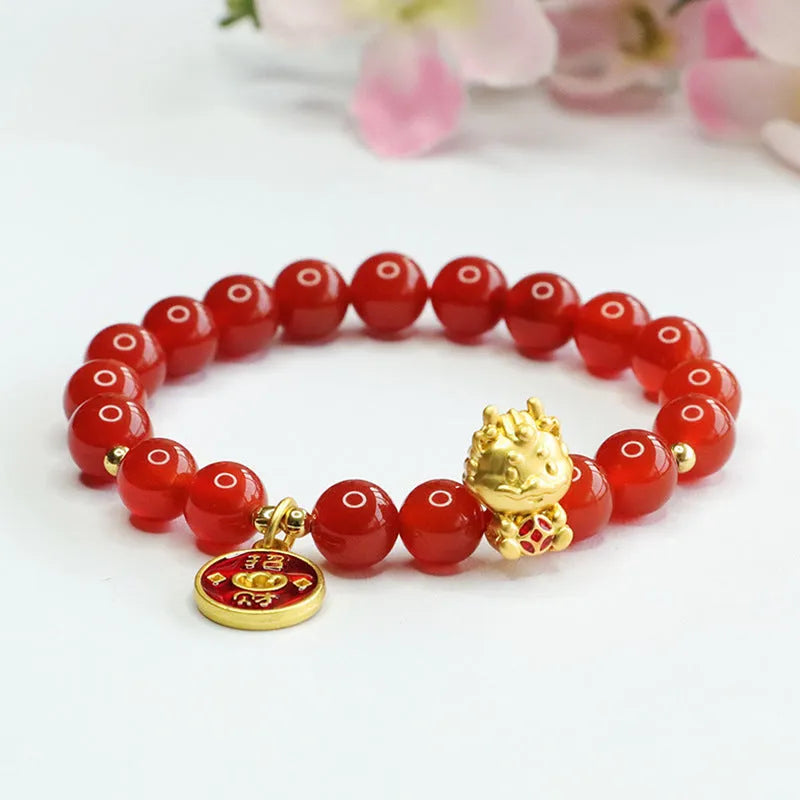 Close-up of a red agate bead dragon zodiac bracelet on a wrist, showing 8mm beads and Chinese style design.