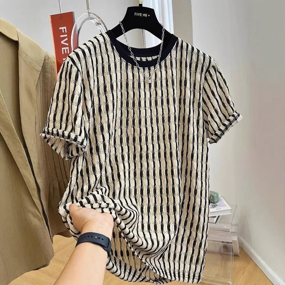 Men's black striped short-sleeve shirt with loose fit, made from linen and silk blend, shown in casual wear.