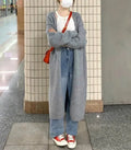 Women's knitted cardigan with V-neck, 65cm length, in khaki colour showing loose fit and long sleeves