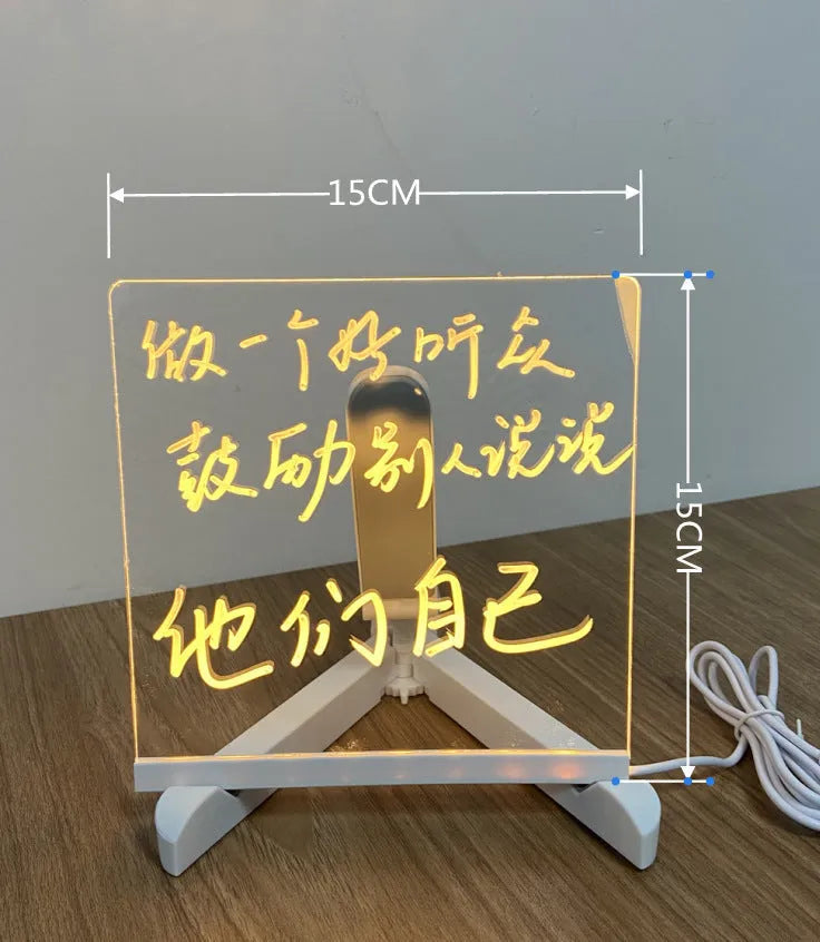 Acrylic DIY LED message board night light on a desk with handwritten drawing glowing softly.