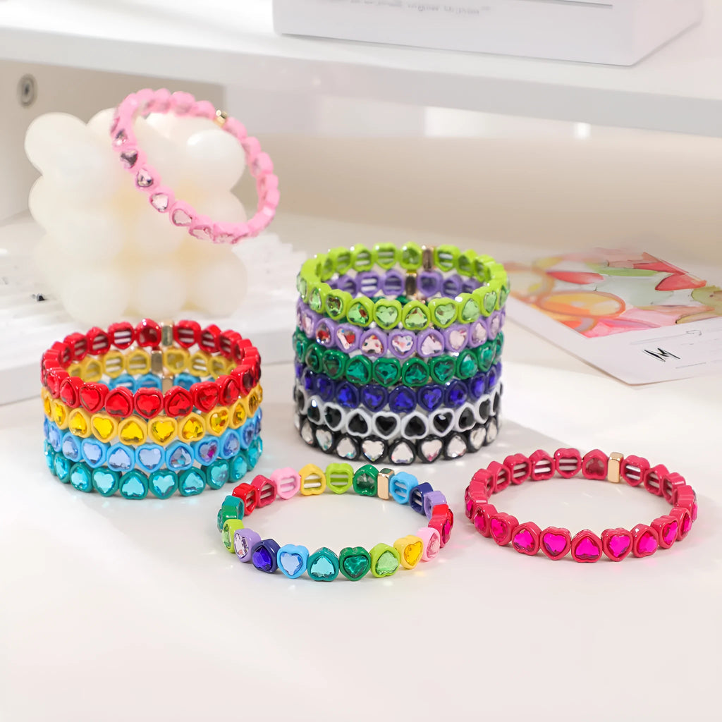 Colourful enamel heart charm on a stretch alloy bracelet.