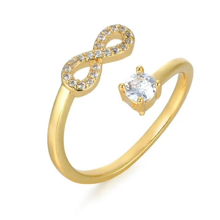 Geometric open zircon ring showing letter personalisation option with inlaid stones and metal construction
