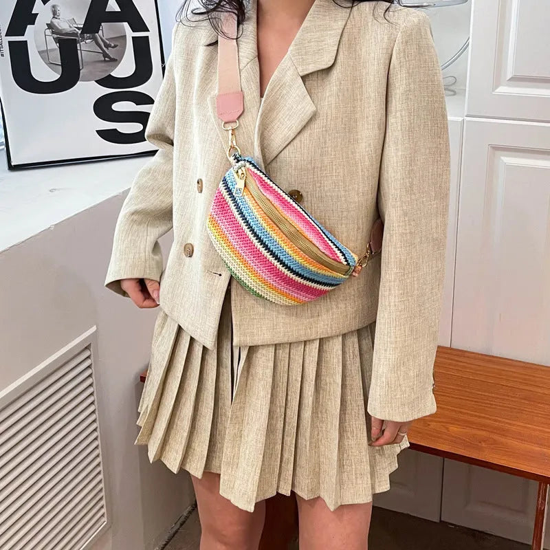 Blue straw woven women's shoulder bag with shell shape and single strap showing sandwich pocket detail