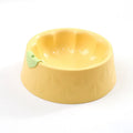 Flower-shaped green plastic double pet bowl for cat and dog food and water on a white surface.
