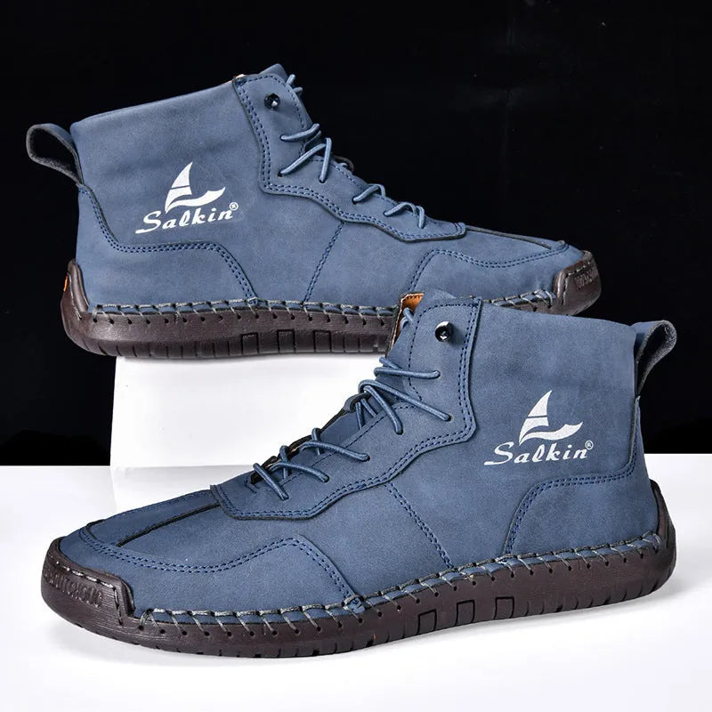 A pair of beige retro high-top casual leather boots with a round toe and elastic band fastening on a plain background.