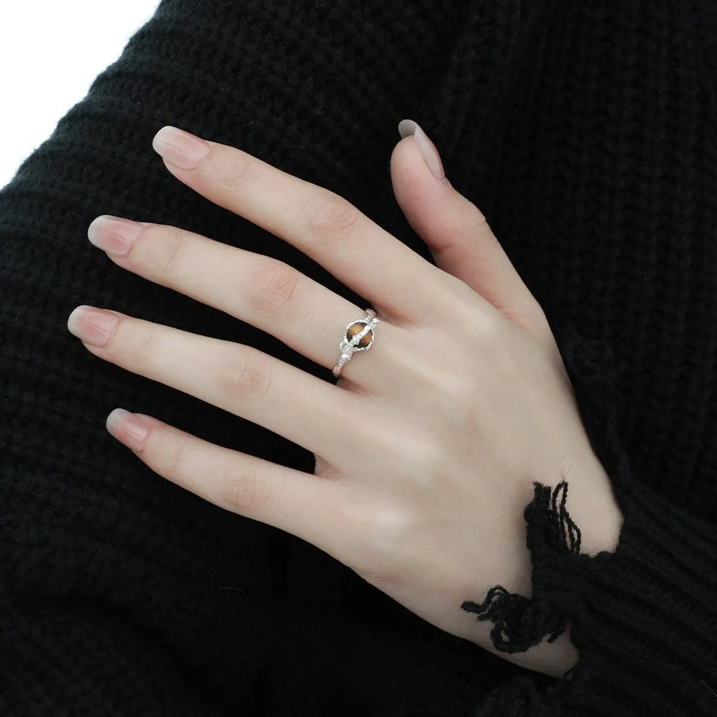 Women's adjustable Saturn open ring in electroplated white gold colour showing original design and adjustable opening mechanism