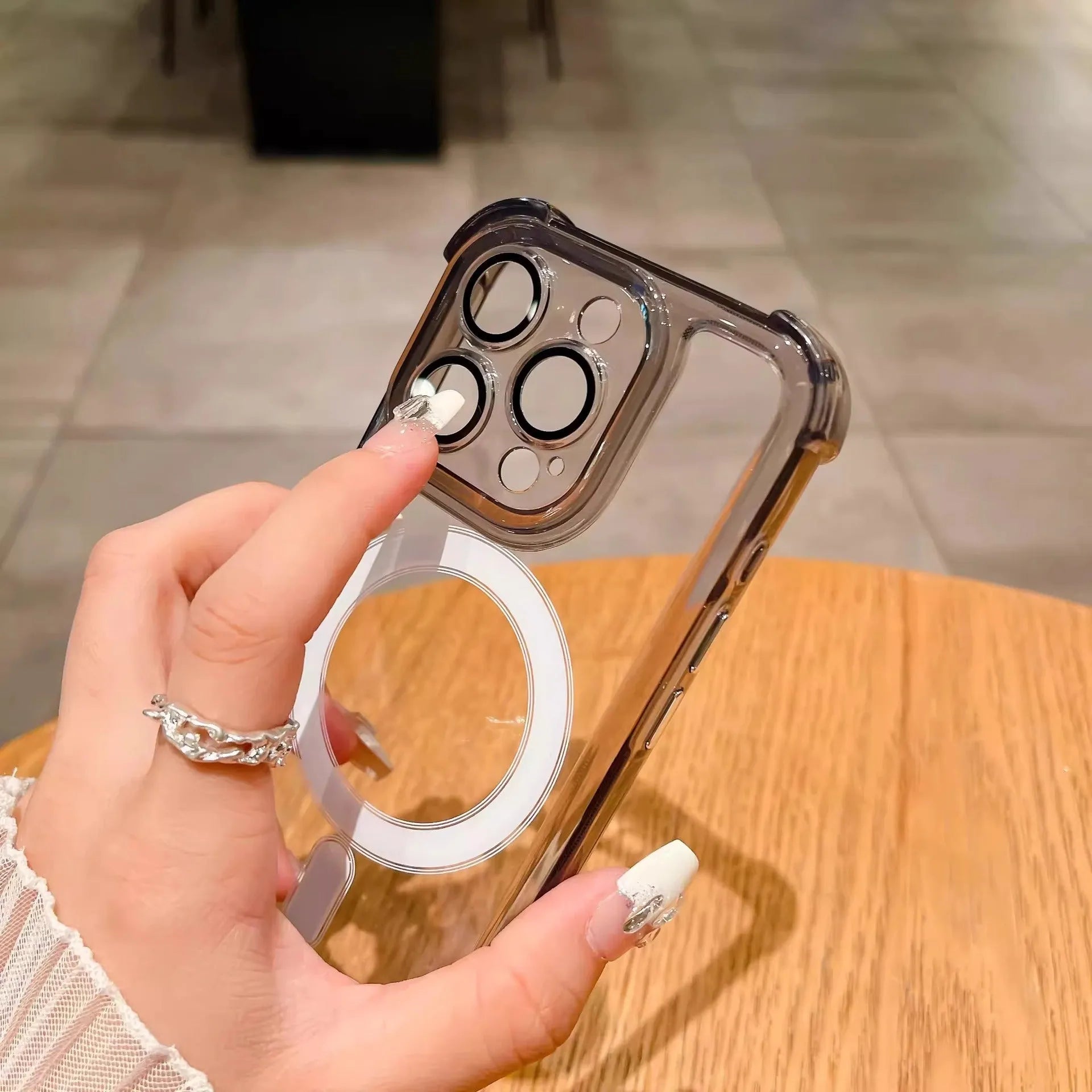 Transparent airbag silicone phone case for iPhone with built-in camera lens protector.