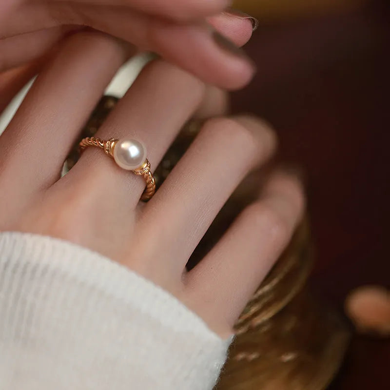 Adjustable copper ring with geometric pearl inlay in antique twist pattern, showing gold and silver finish options