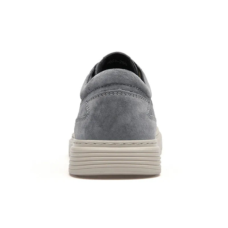 Men's grey casual skate shoes with pigskin upper and rubber sole showing lace-up front and round toe design