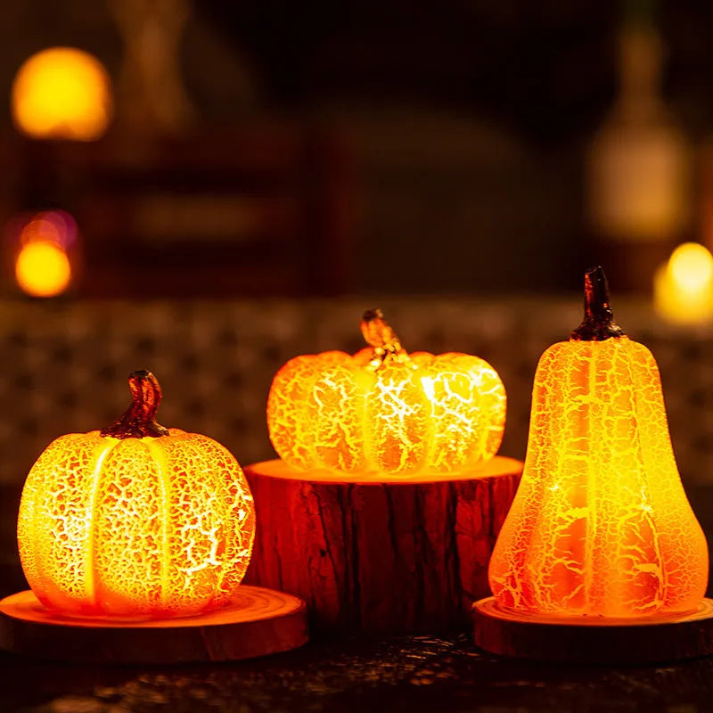 Set of three resin Halloween pumpkin lanterns with LED candle lights in short, medium, and long sizes.