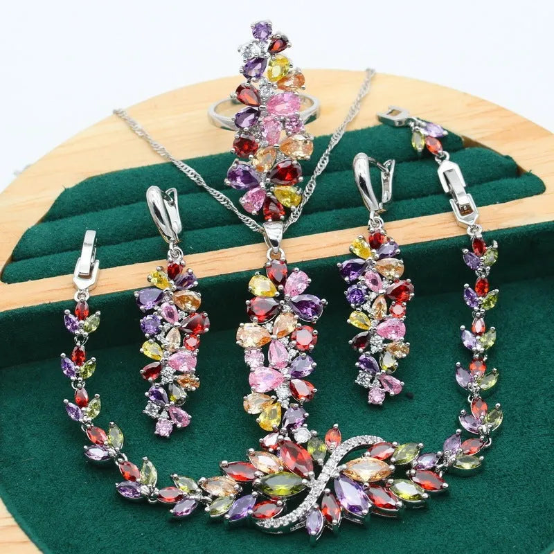 Retro jewellery set with botanical patterns in olive or purple, showing bracelet, necklace, earrings, and ring