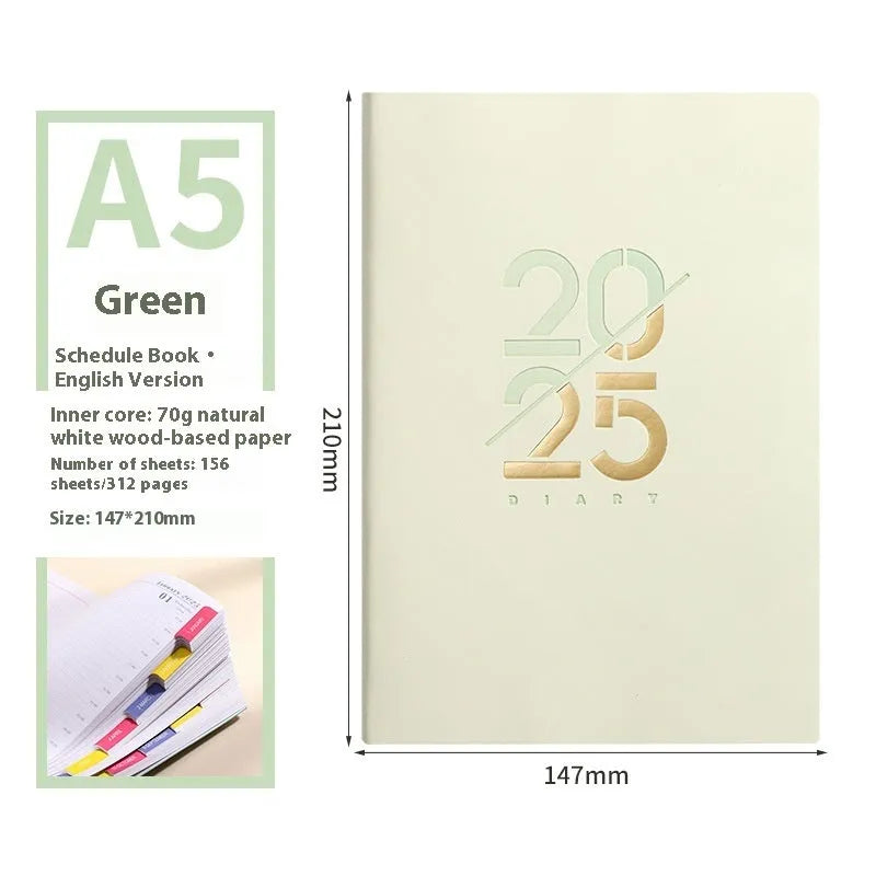 2025 A5 schedule book with faux leather cover in blue, showing open pages on a desk