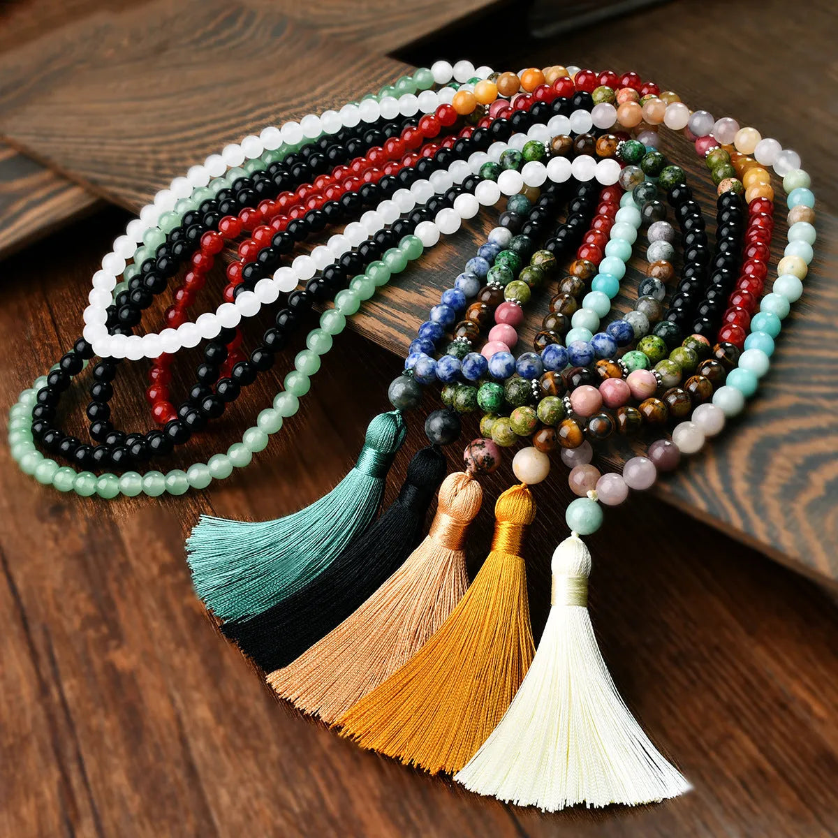 Long beaded bohemian necklace with 108 gemstone tassel pendants on a ball chain.