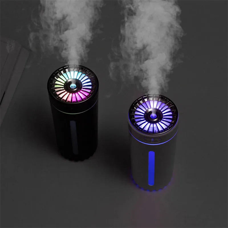 Black portable USB rechargeable humidifier with colourful LED lights on a car cup holder.