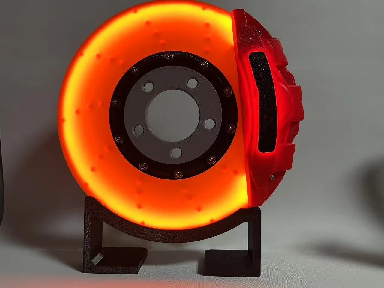 Blue brake disc LED rechargeable night light with touch dimmer on a desktop