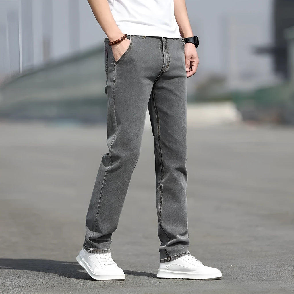 Men's straight leg jeans in smoky gray with low waist and zipper fly closure