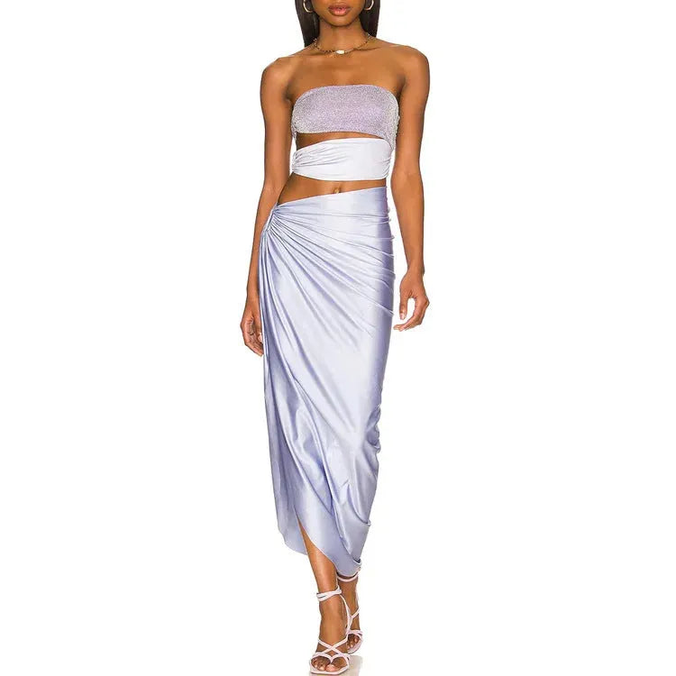 Purple one-piece swimsuit with high-cut legs and a matching wrap skirt laid flat.