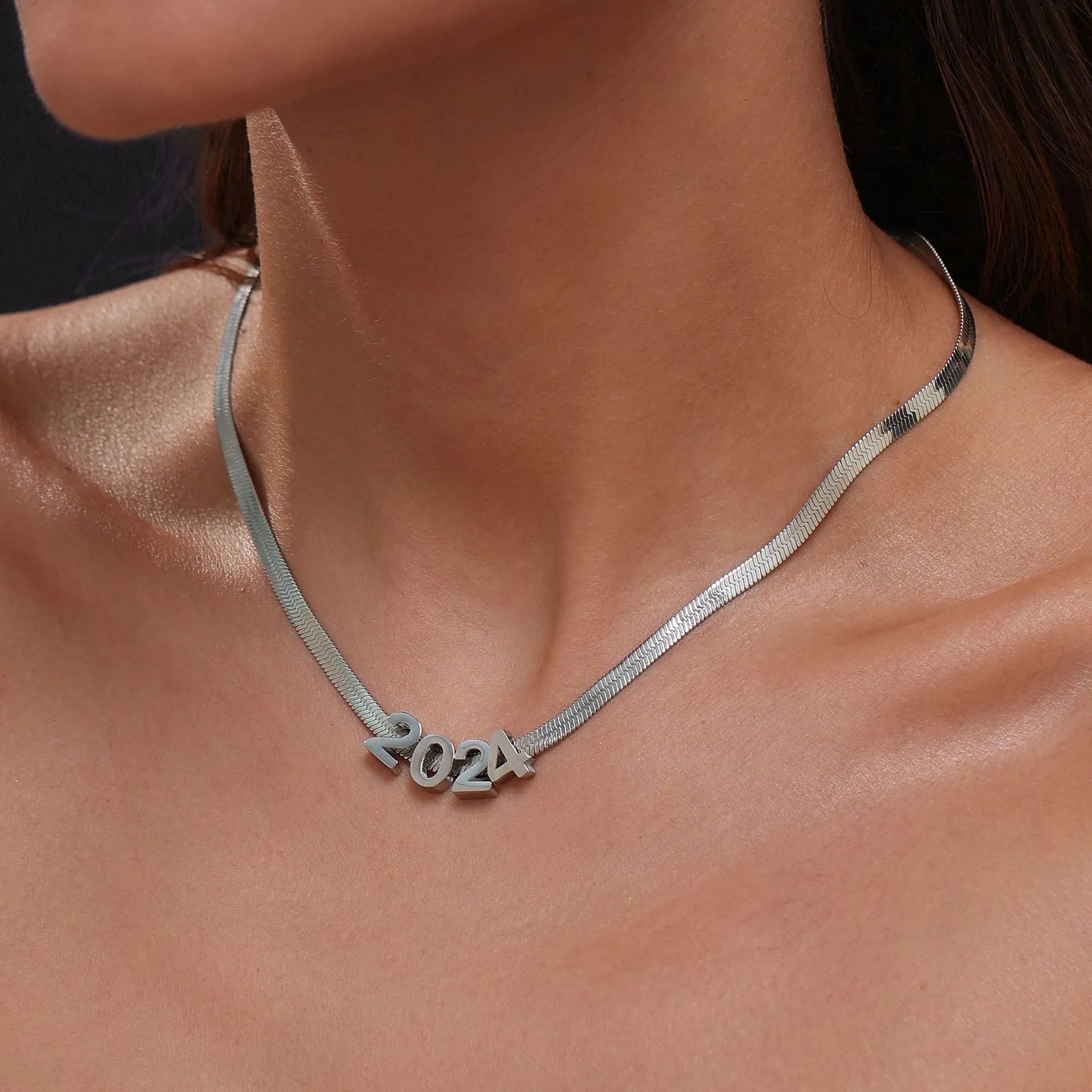 Titanium steel necklace with 40.5cm chain and electroplated gold charms showing numbers and letters for personalisation