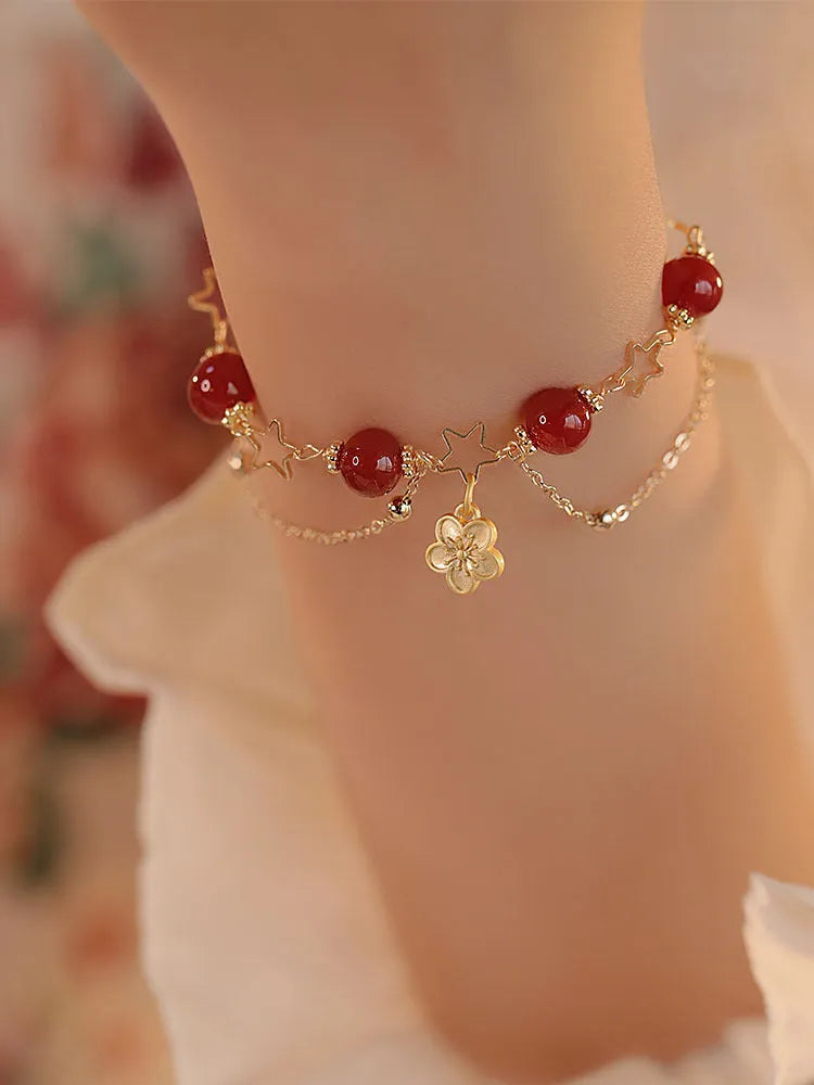 Women's red agate double layer bracelet with floral motifs and adjustable sliding knot closure