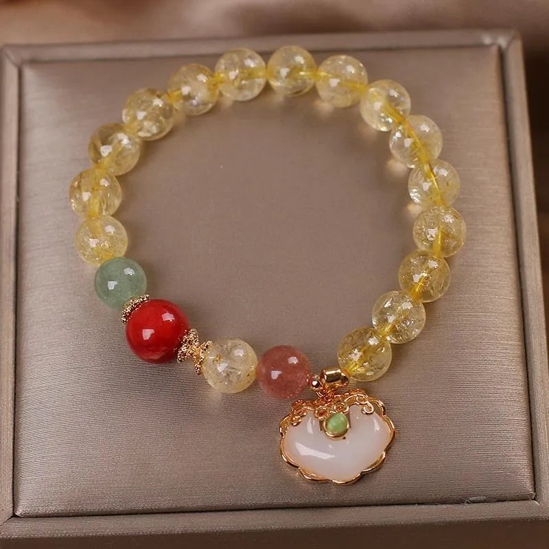 Women's bracelet with a yellow hair crystal jade ruyi pendant on an alloy chain.