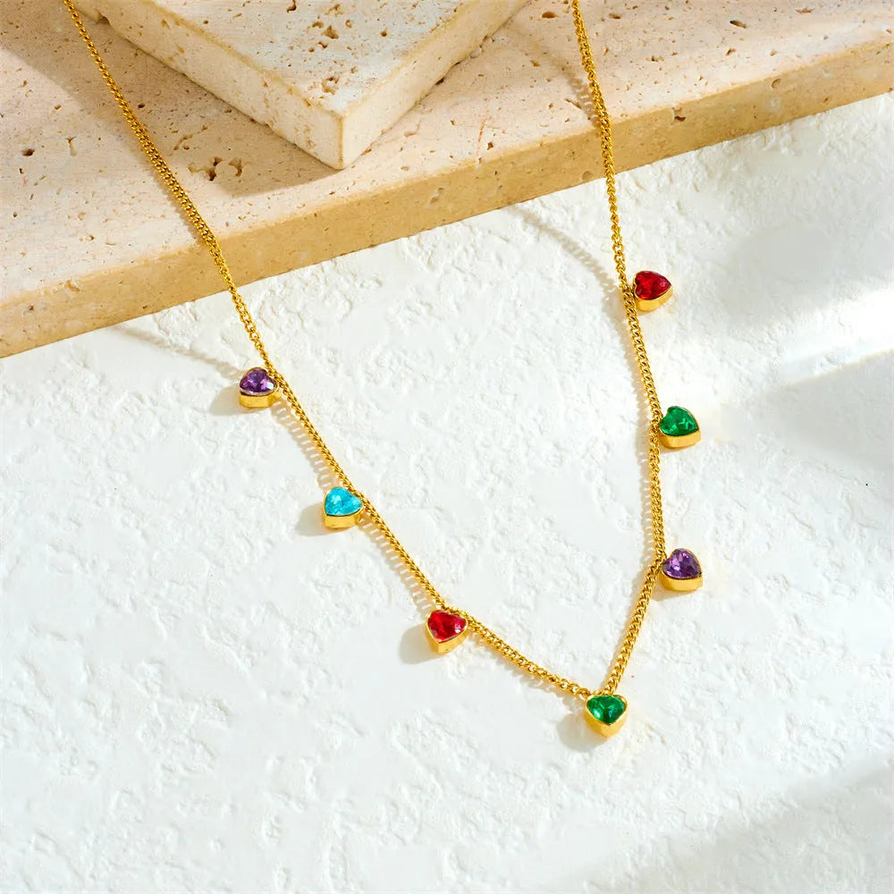 Gold-coloured stainless steel necklace with a heart pendant on an adjustable chain.