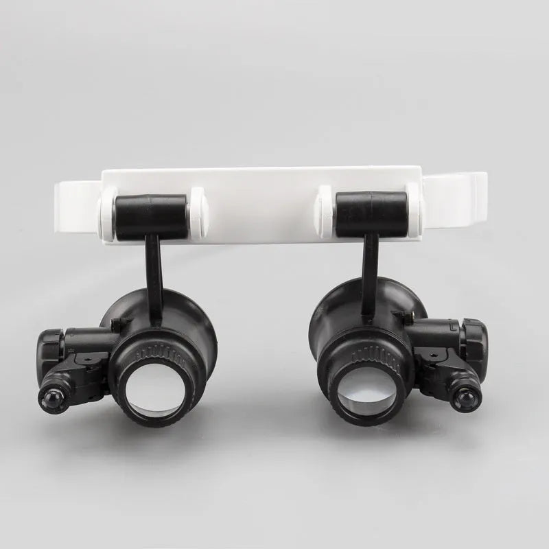 White head mounted magnifying glass with 30mm lenses and LED light for clock and antique glass repair