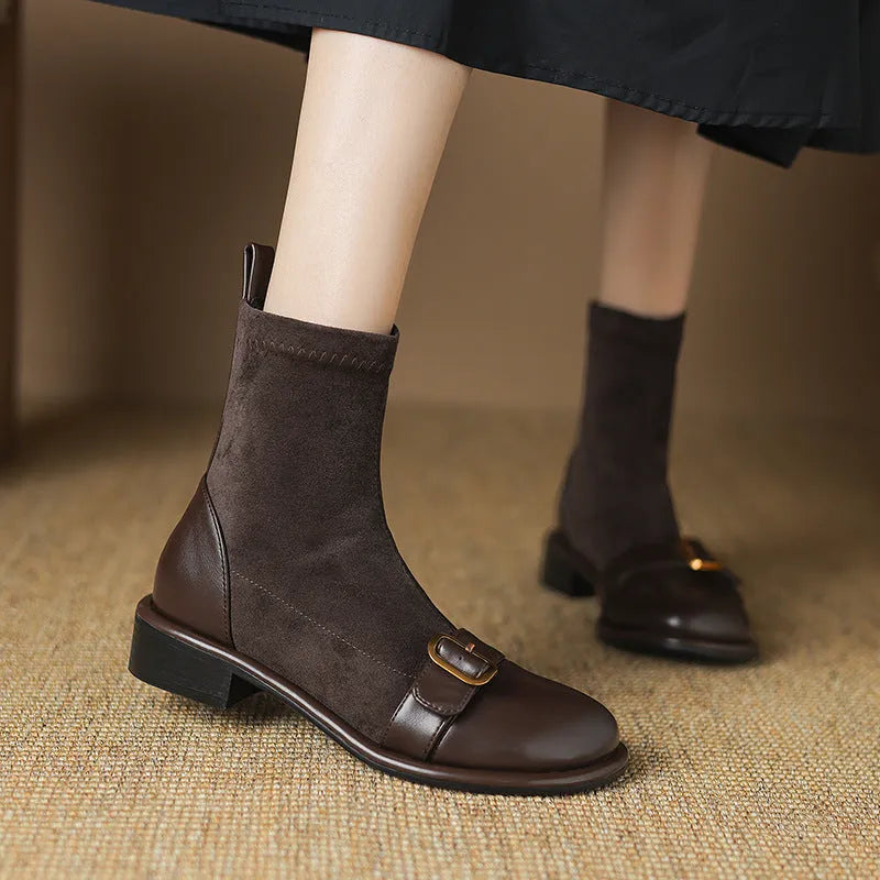 Women's black low heel Martin boots with lace-up front and belt buckle detail.