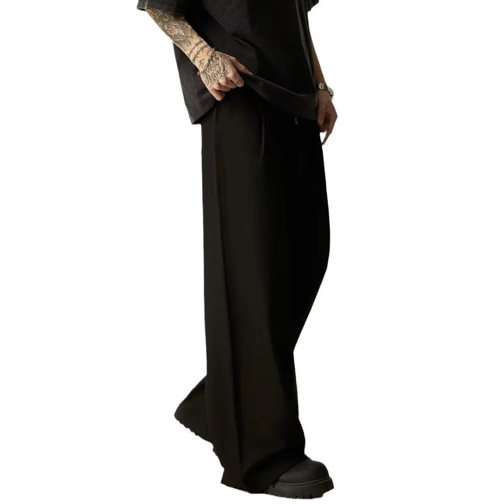 Men's black casual trousers with elastic waistband and straight-leg design on hanger