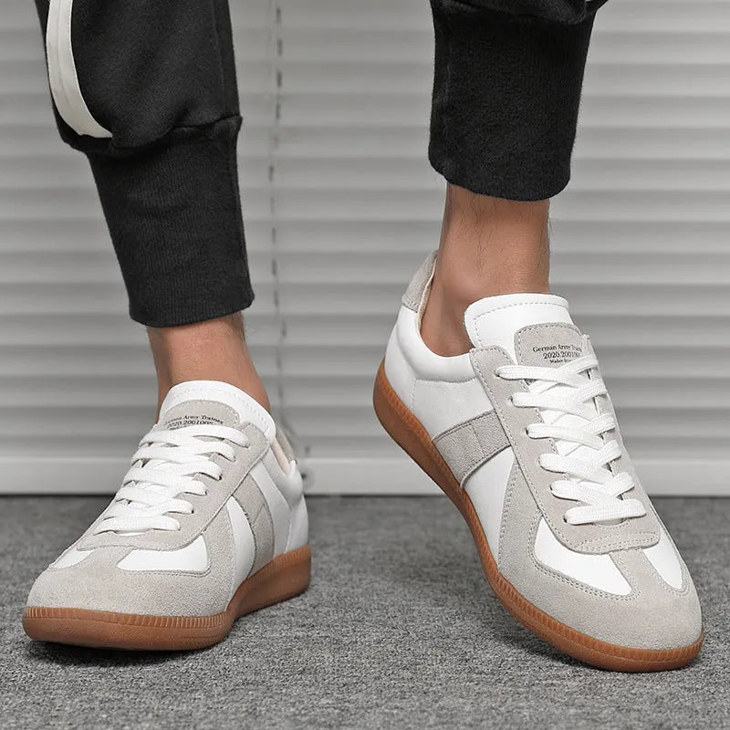 White Japanese-style retro unisex board shoes with lace-up front and round toe on a rubber sole.
