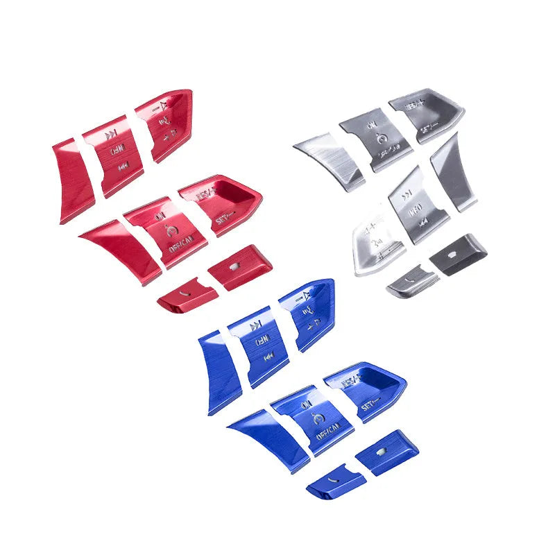 Set of eight aluminium alloy steering wheel button stickers in brushed red, silver, and blue finishes